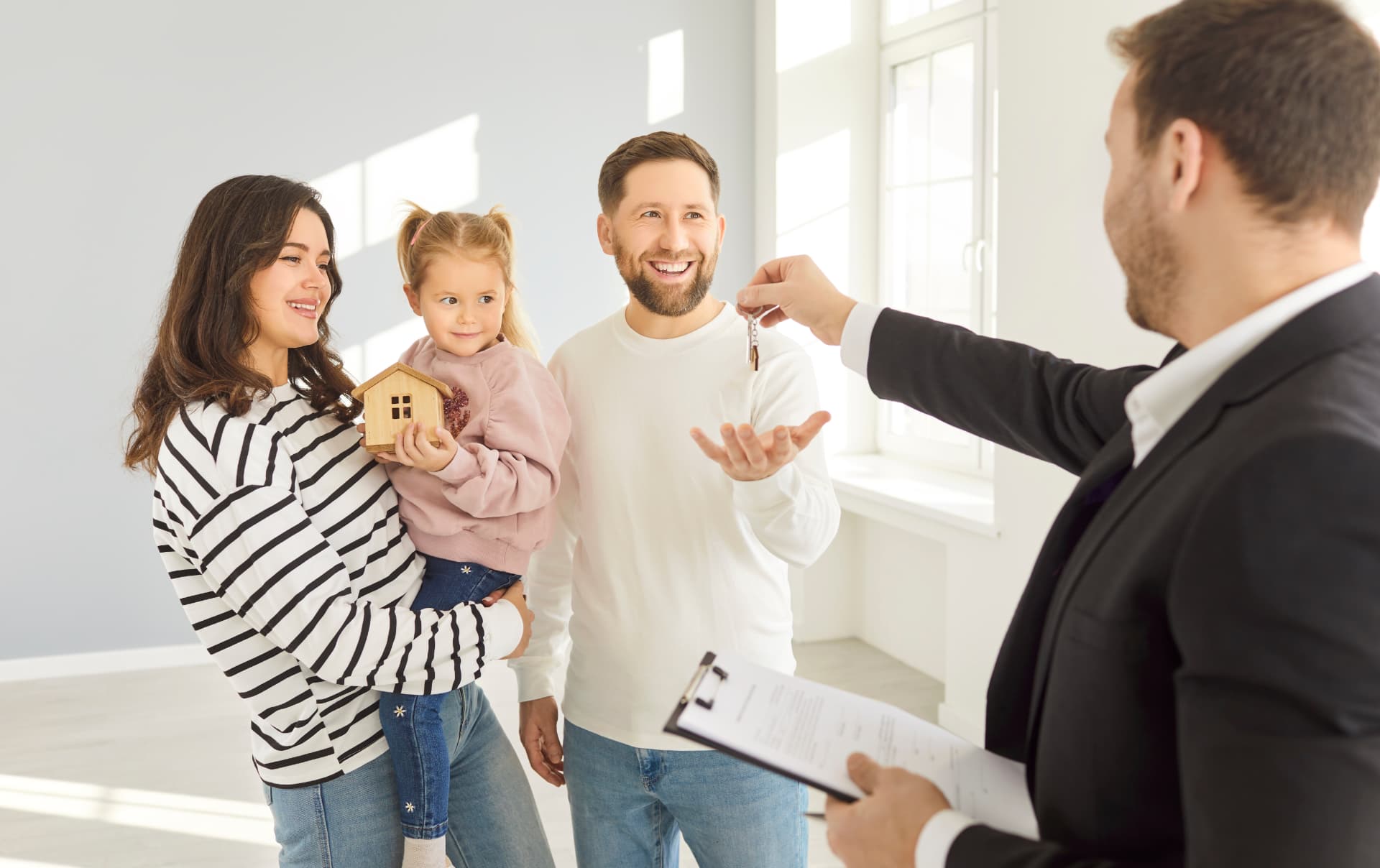 Happy family receiving keys to their new SageLeaf home